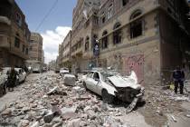 People inspect the site of an airstrike by Saudi-led coalition in Sanaa, Yemen, Thursday, May, ...