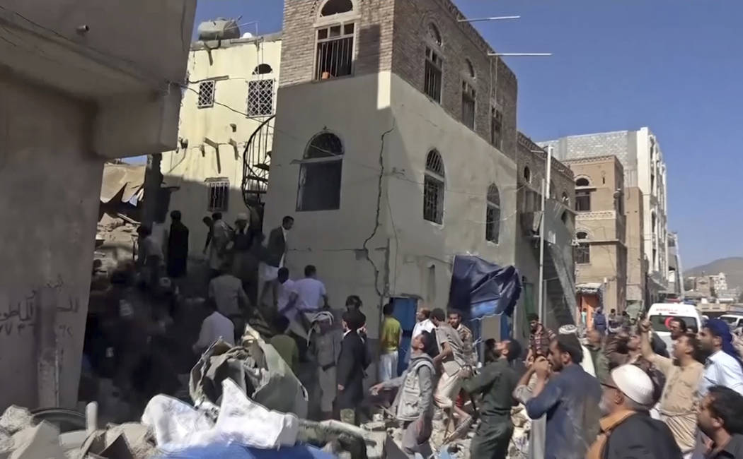 In this frame grab from from video, people search in the rubble following Saudi-led coalition a ...