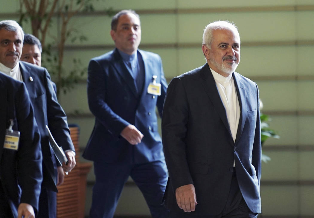 Iranian Foreign Minister Mohammad Javad Zarif, right, walks to meet Japanese Prime Minister Shi ...