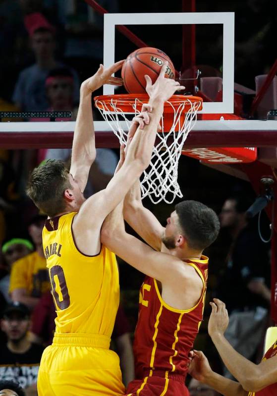 Arizona State forward Vitaliy Shibel, left, dunks against Southern California forward Nick Rako ...