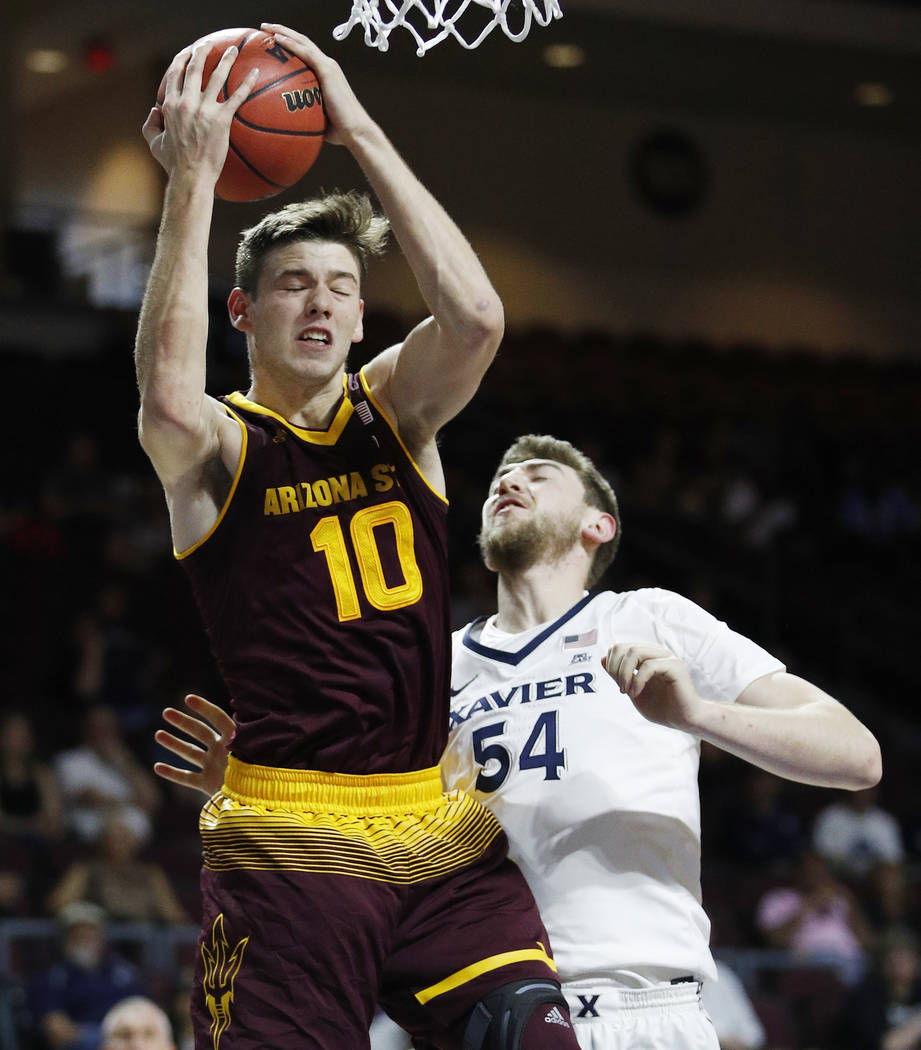 Arizona State's Vitaliy Shibel grabs a rebound over Xavier's Sean O'Mara during the first half ...