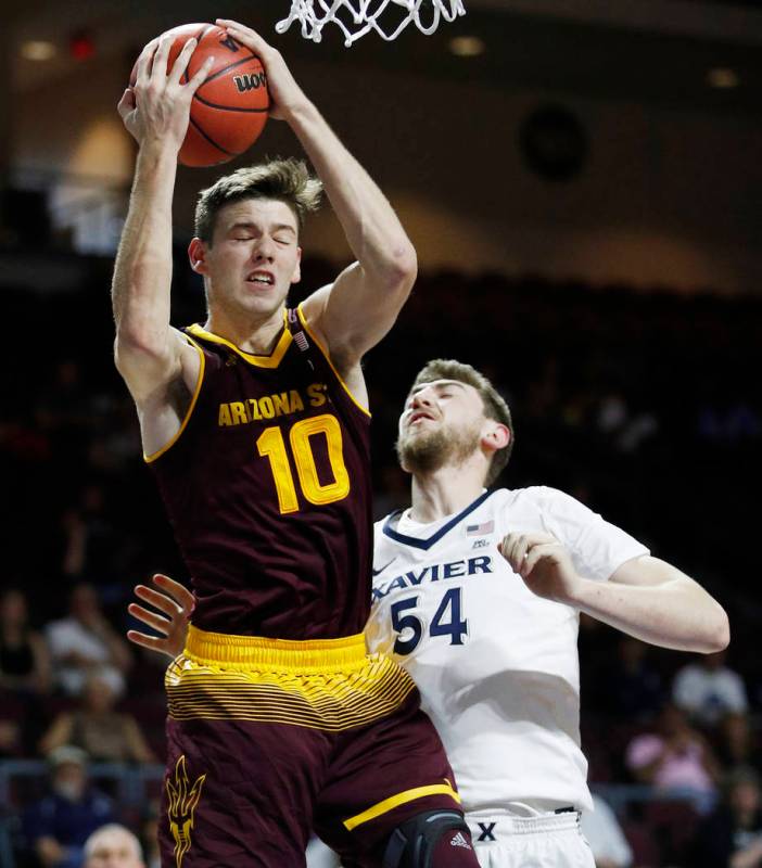 Arizona State's Vitaliy Shibel grabs a rebound over Xavier's Sean O'Mara during the first half ...