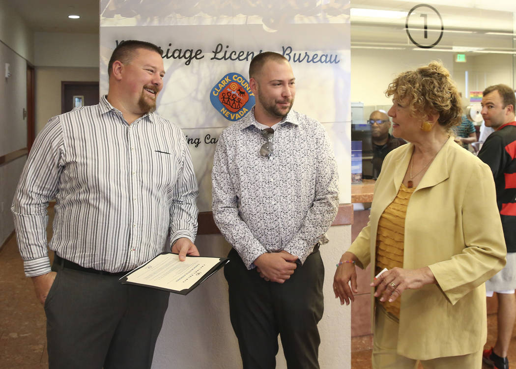 James Johnson, left, and his partner Matthew Tipple, both of DeBary, Fla., chat with County Cle ...