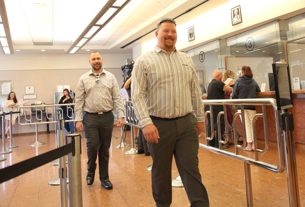 James Johnson, front, and his partner Matthew Tipple, both of DeBary, Fla., arrive at the Clark ...