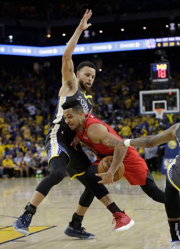 Portland Trail Blazers guard CJ McCollum, right, drives against Golden State Warriors guard Ste ...