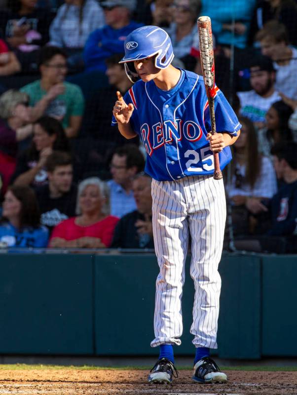 Reno batter Garryson Grinsell (25) takes direction from his coach versus Desert Oasis in the fo ...