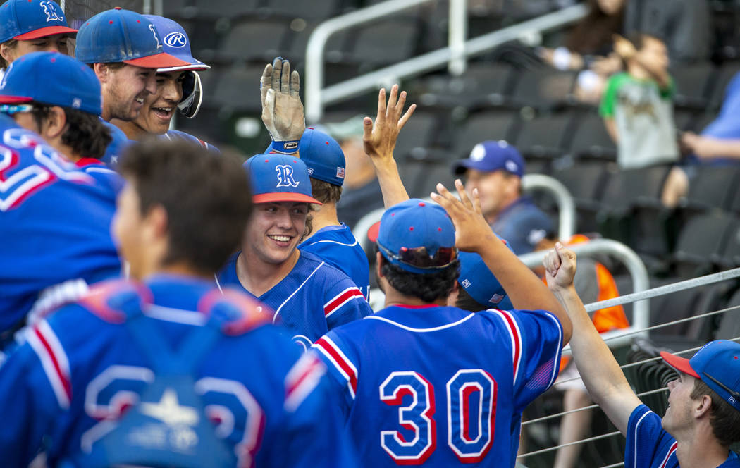 Reno players celebrate their game-winning runs in the sixth inning versus Desert Oasis during t ...