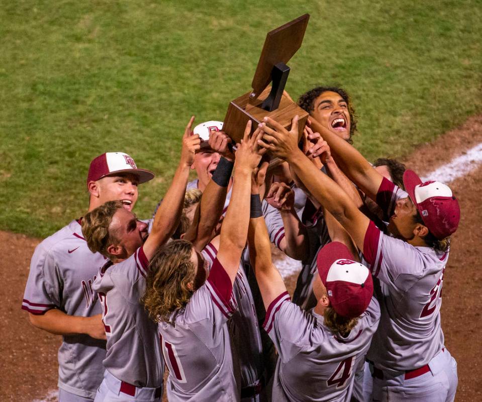 Desert Oasis players celebrate their trophy after defeating Reno 9-1 during the tie-breaker gam ...