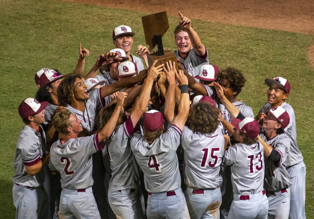 Desert Oasis players celebrate their trophy after defeating Reno 9-1 during the tie-breaker gam ...