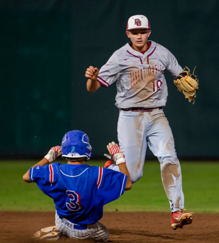 Reno runner Garrett Damico (3) arrives late at second base as Desert Oasis' Colby Smith (10) ma ...