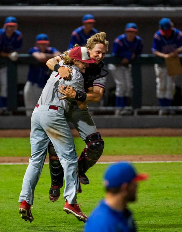 Desert Oasis pitcher Josh Sharman (11) celebrates their win with catcher Parker Schmidt (4) ove ...