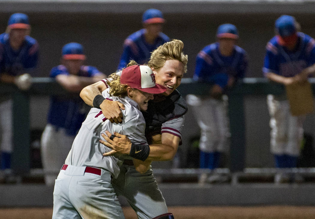 Desert Oasis pitcher Josh Sharman (11) celebrates their win with catcher Parker Schmidt (4) ove ...