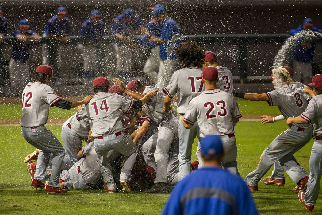 Desert Oasis players celebrate their win over Reno 9-1 during the tie-breaker game of their Cla ...