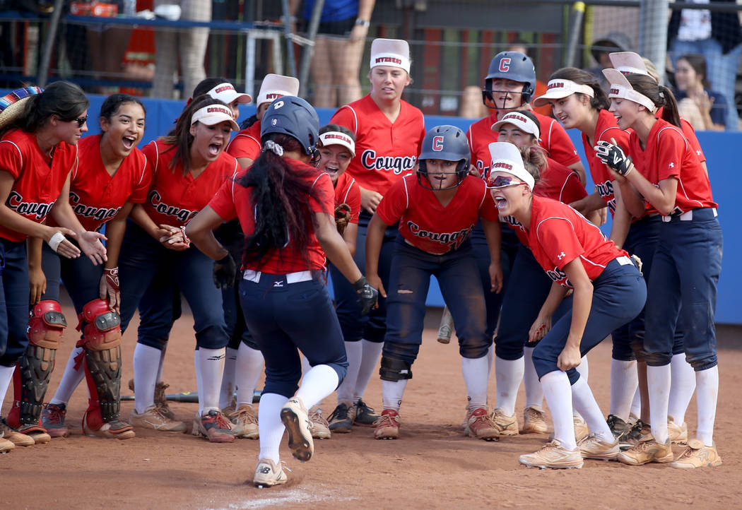 Coronado players celebrate a two-run home run by Kaila Angel (9) against Shadow Ridge in their ...