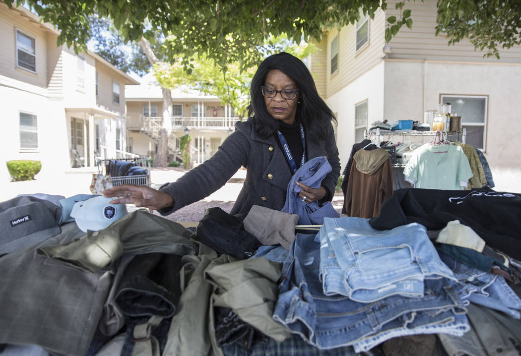 Melody Shay, property manger for Desert Plaza Senior Apartments, organizes clothing at a commun ...