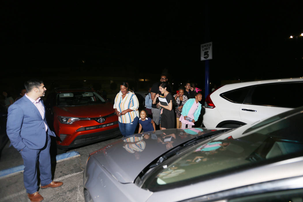 Principal John Anzalone, far left, waits for Tyria Smith to see her new car at Sierra Vista Hig ...