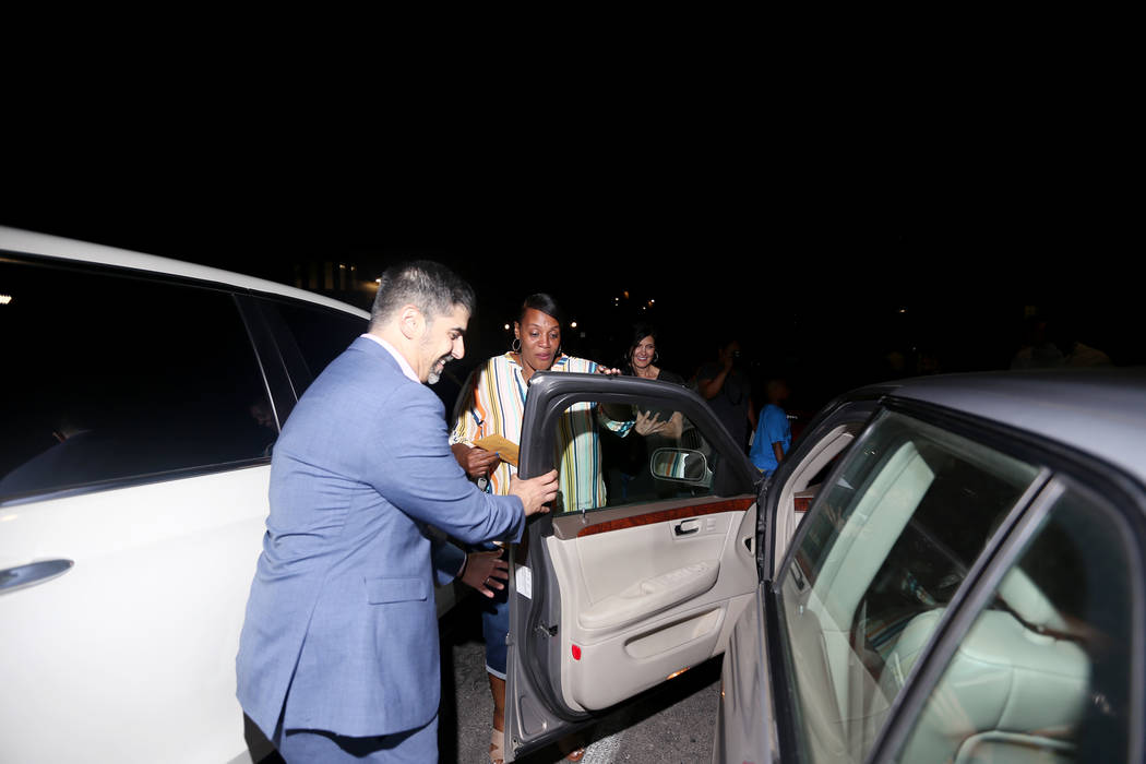 Principal John Anzalone opens the door for Tyria Smith to her new car at Sierra Vista High Scho ...