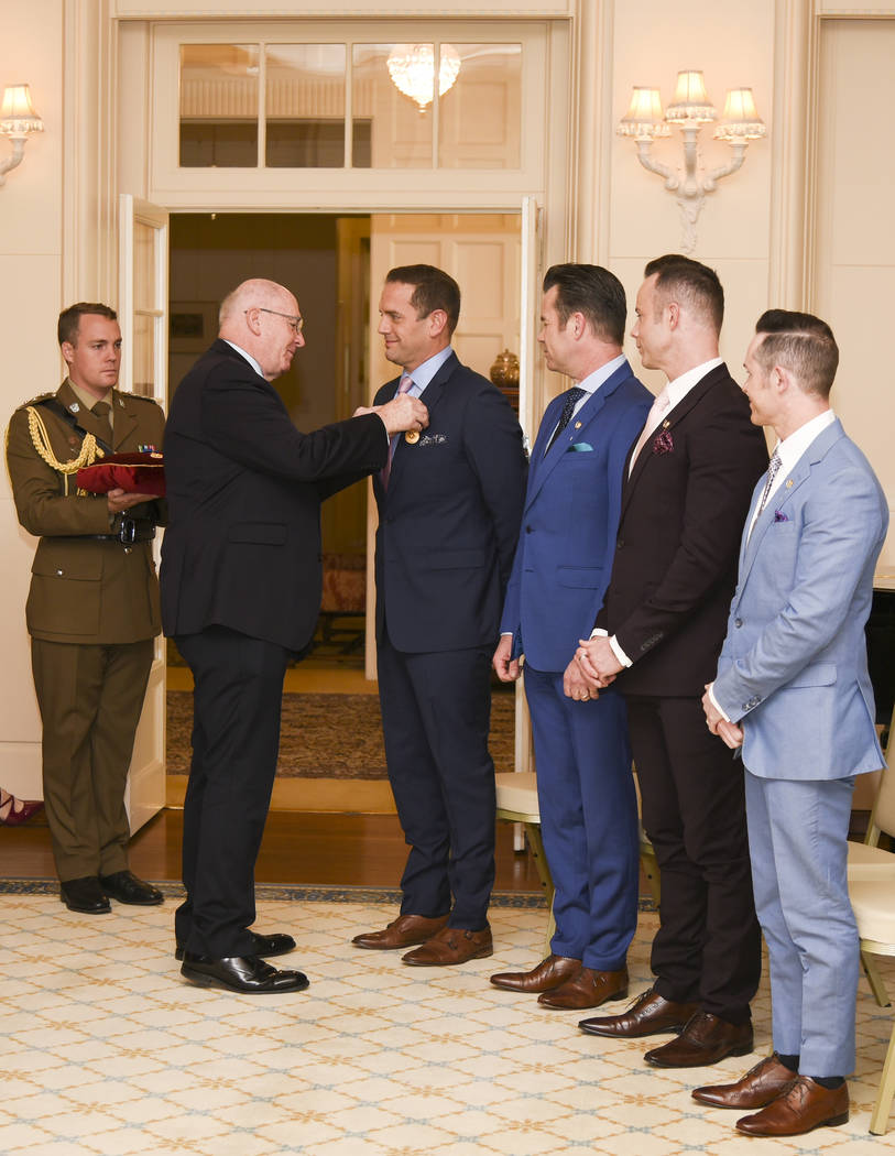 Peter Cosgrove, the Governor-General of the Commonwealth of Australia, awards members of Human ...