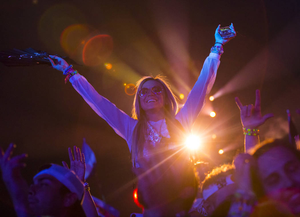 Attendees dance as Alesso performs at the Kinetic Field stage during the first day of the Elect ...