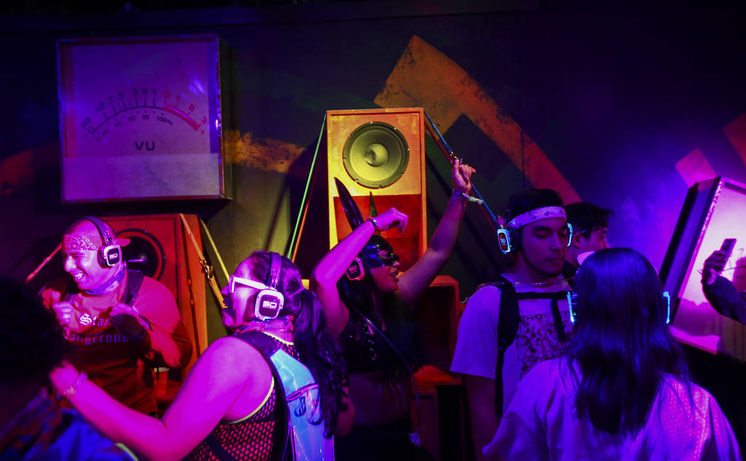 Attendees dance at a silent disco dance room during the first day of the Electric Daisy Carniva ...