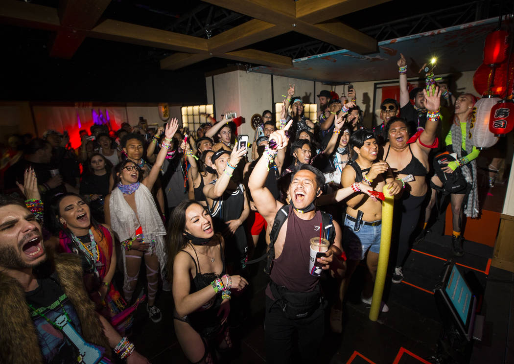 Attendees cheer on performers at the karaoke bar at the Downtown EDC area during the first day ...