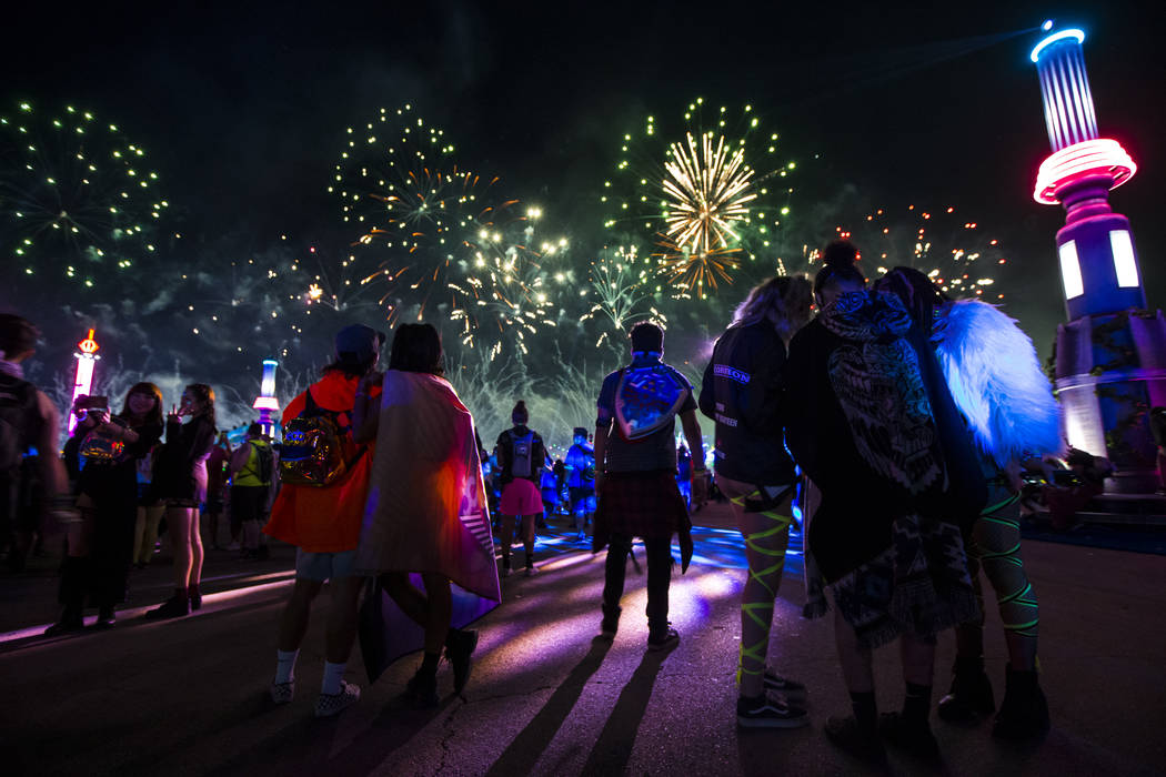 Attendees watch fireworks go off during the first day of the Electric Daisy Carnival at the Las ...