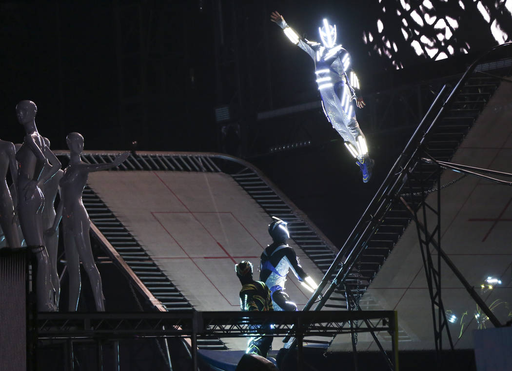 Performers wearing lit-up suits perform aerial stunts during the first day of the Electric Dais ...