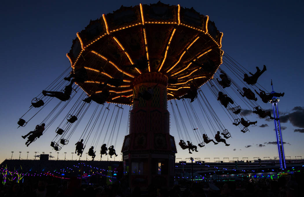 Attendees on a carnival ride during the first day of the Electric Daisy Carnival at the Las Veg ...