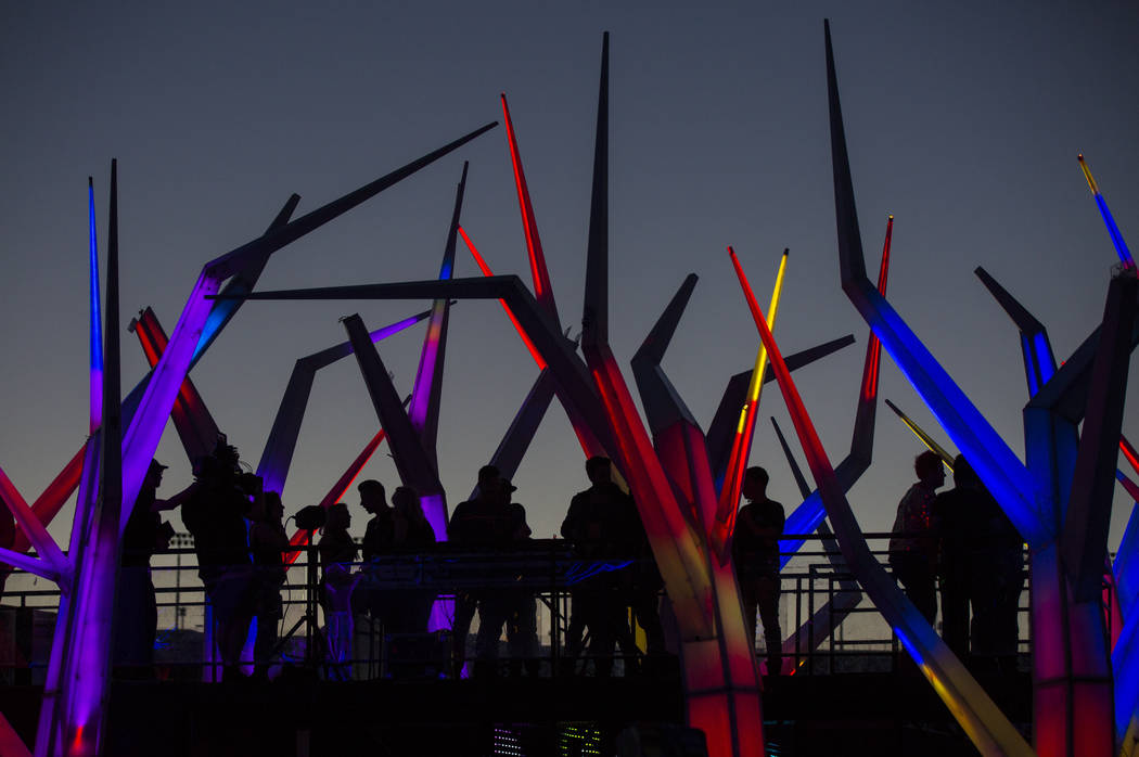 Attendees are silhouetted on top of the Forest House Art Car during the first day of the Electr ...