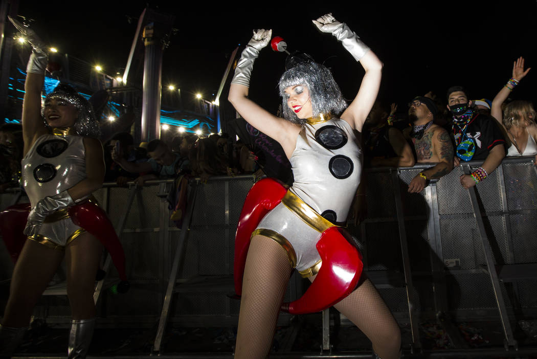 Costumed performers entertain attendees as Excision performs at the Kinetic Field stage during ...