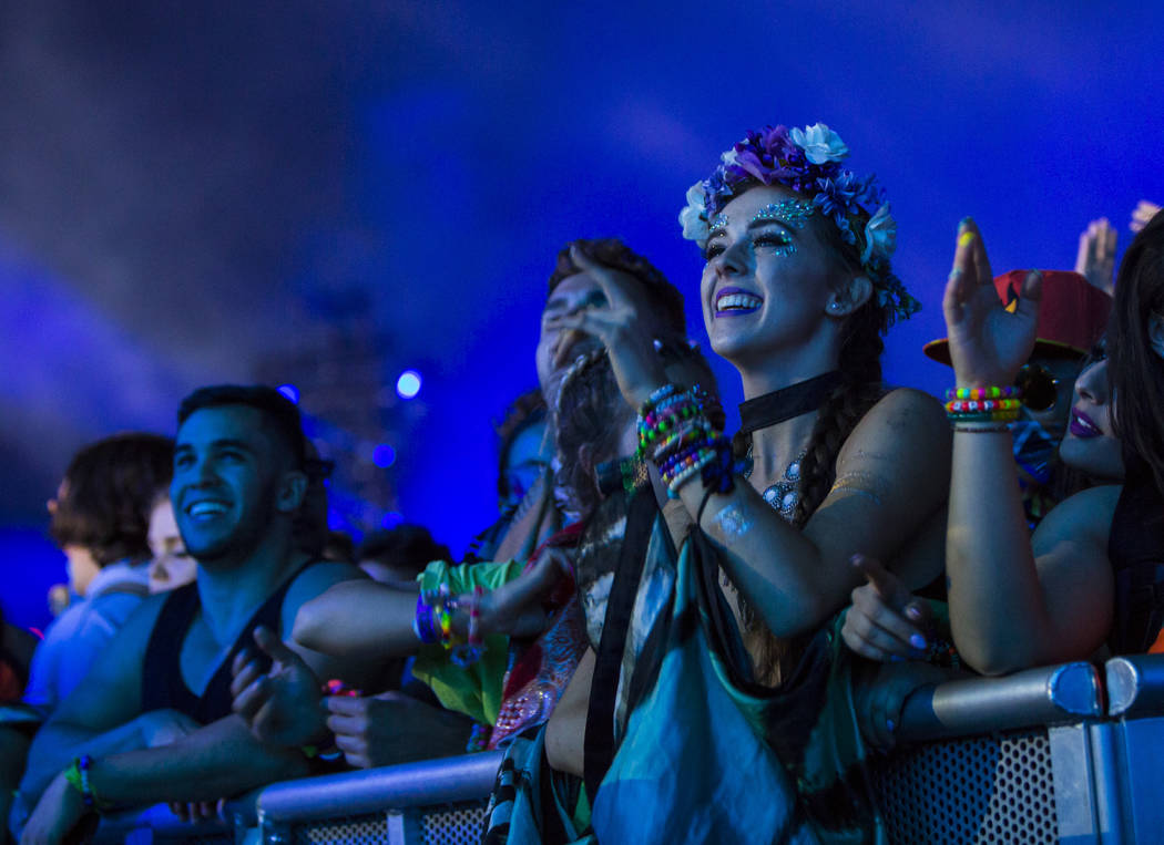 Attendees react as Excision performs at the Kinetic Field stage during the first day of the Ele ...