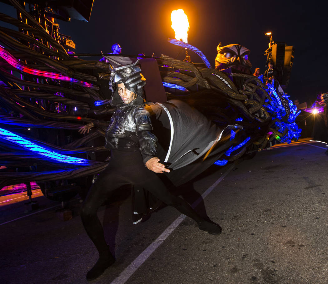 A costumed performer dances outside of the Parliament art car during the second day of the Elec ...