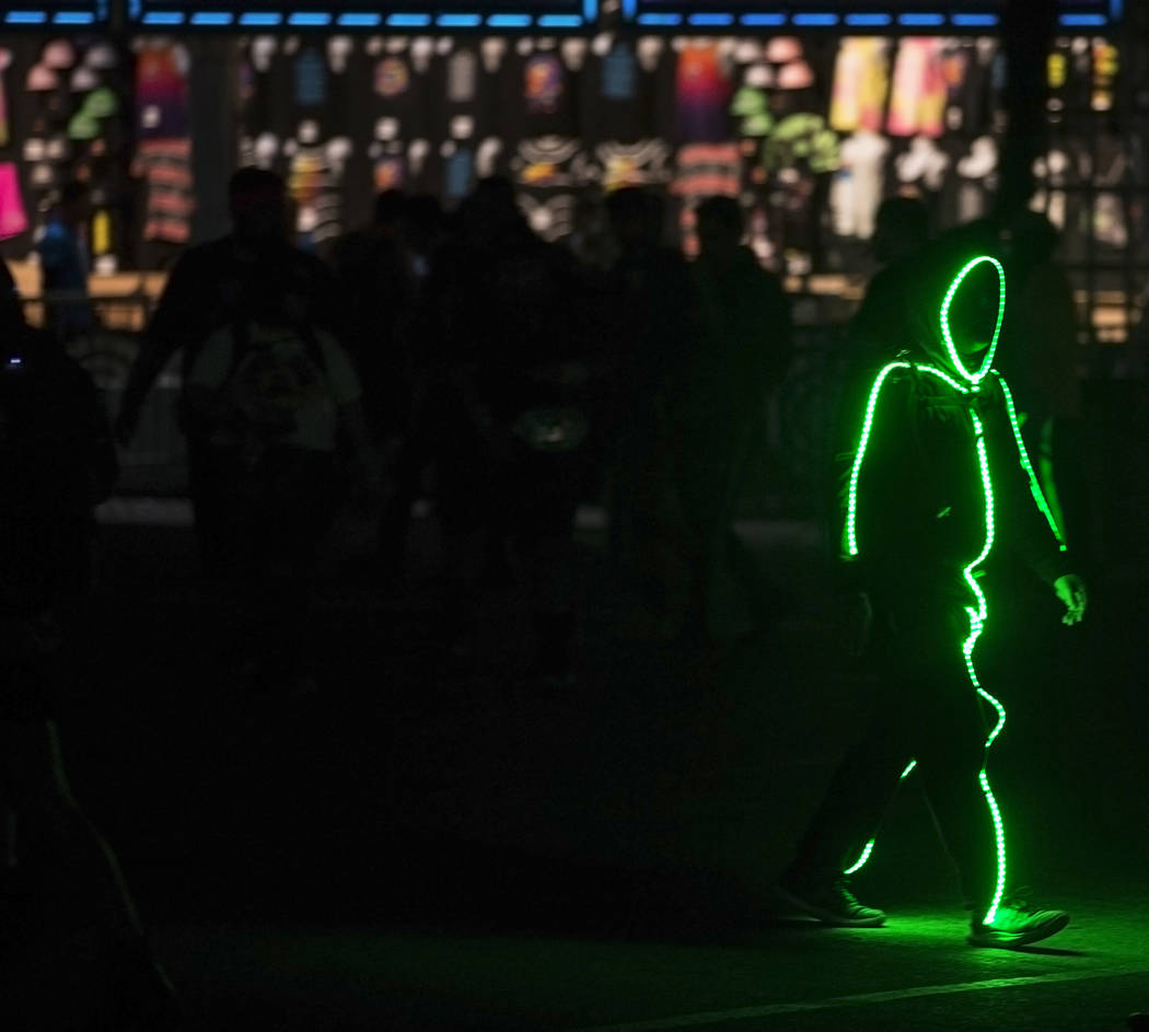A neon shadow makes his way to the Cosmic Meadow stage during day two of Electric Daisy Carniva ...