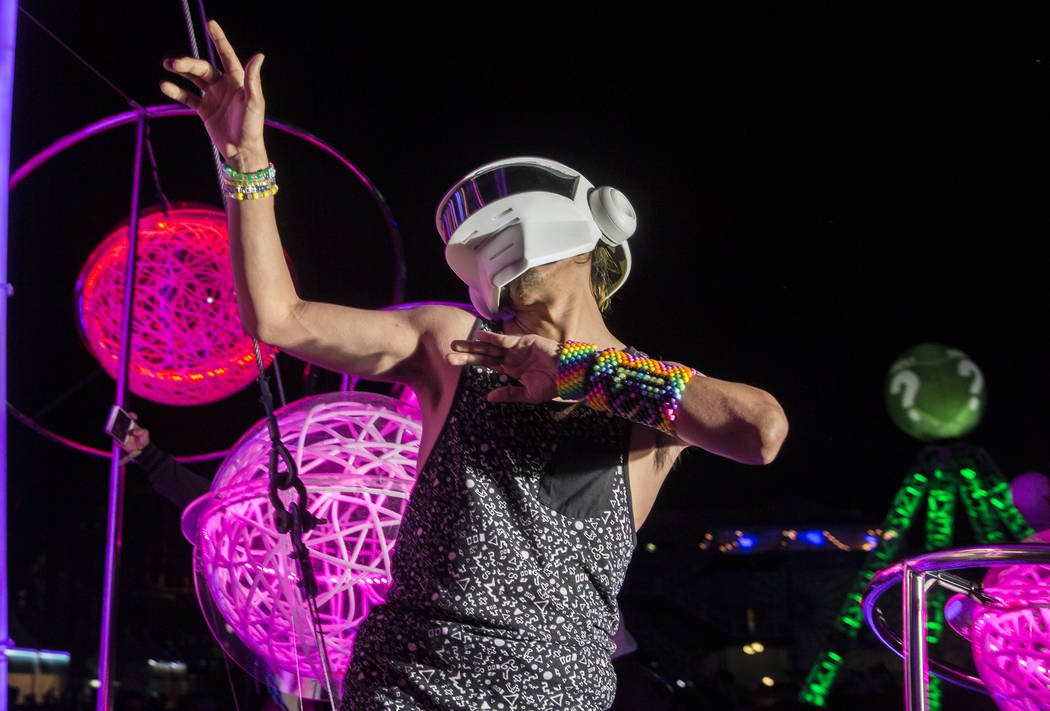 Sergio Gonzalez, from Los Angeles, Calif., dances outside the Cosmic Meadow stage on day three ...