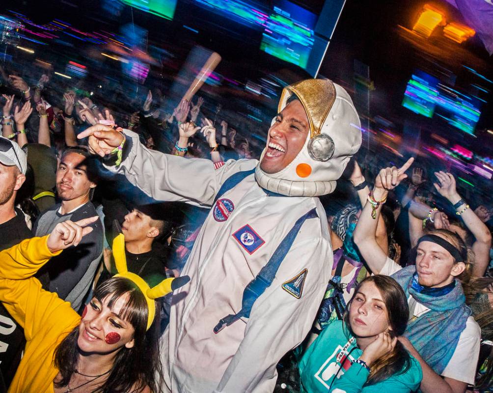 Victor Aballai, middle, and Maria Cunvi, left, dance during Steve Aoki's performance at the Cir ...