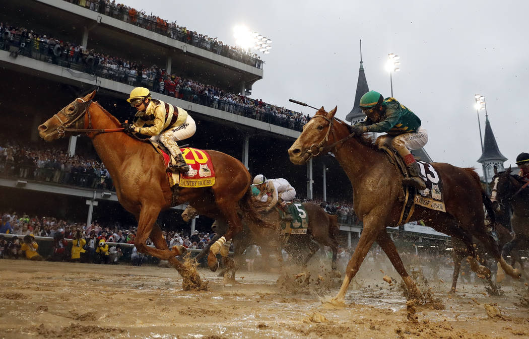 Flavien Prat rides Country House to the finish line during the 145th running of the Kentucky De ...