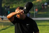 Tiger Woods removes his hat after finishing the second round of the PGA Championship golf tourn ...