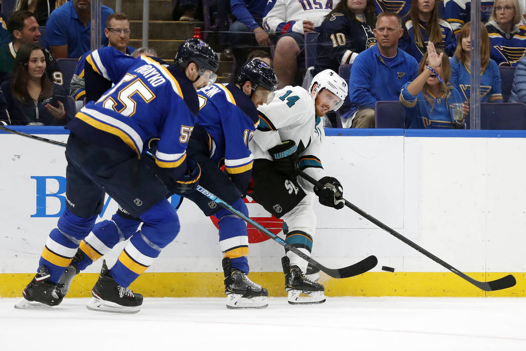 St. Louis Blues defenseman Colton Parayko (55) and center Brayden Schenn (10) battle for the pu ...