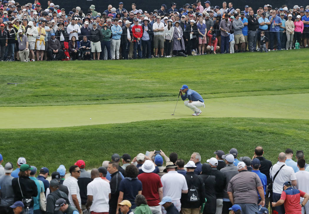 Brooks Koepka lines up a putt on the first green during the second round of the PGA Championshi ...