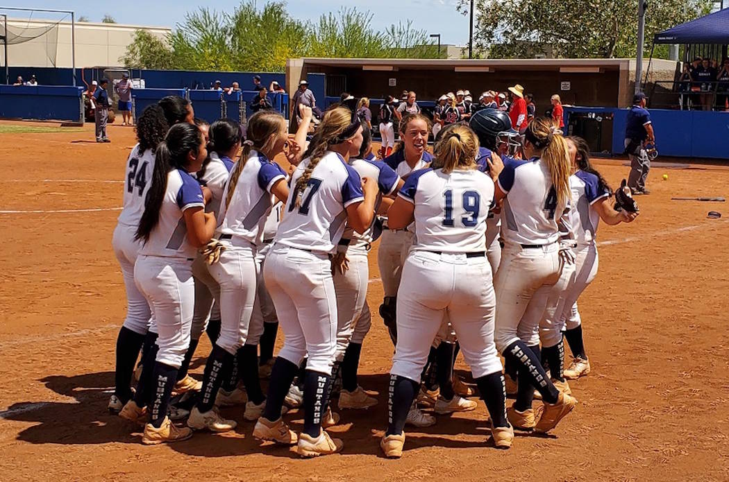 Shadow Ridge players celebrate after Hailey Morrow's single scored Jasmine Martin to give the M ...