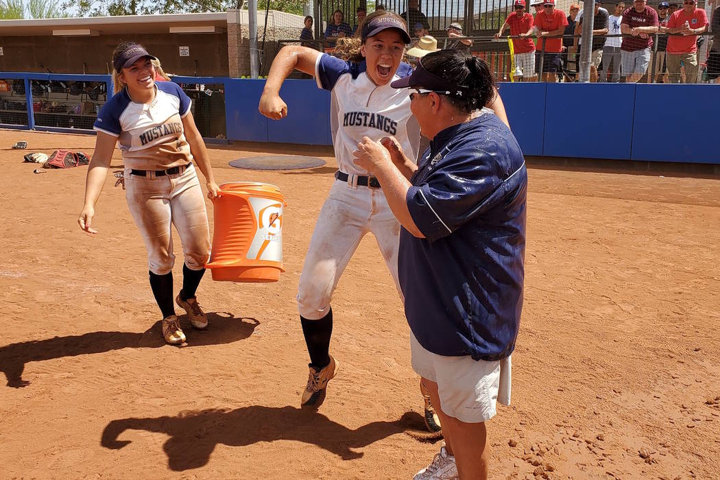 Shadow Ridge's Caitlin Covington (center) celebrates after dousing coach Julie Meyn (right) wit ...