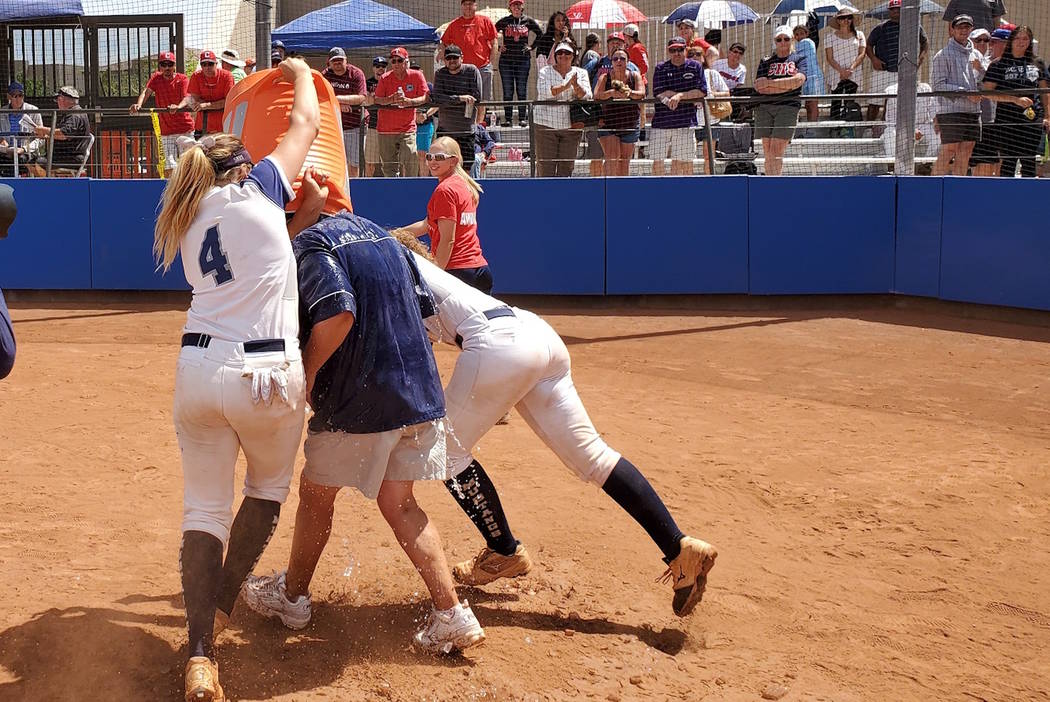 Shadow Ridge's Shea Clements (4) and Caitlin Covington celebrate by dousing coach Julia Meyn af ...