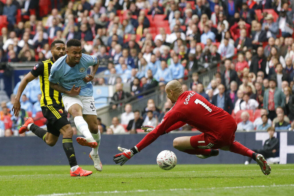 Manchester City's Gabriel Jesus, center, scores his side's fourth goal during the English FA Cu ...