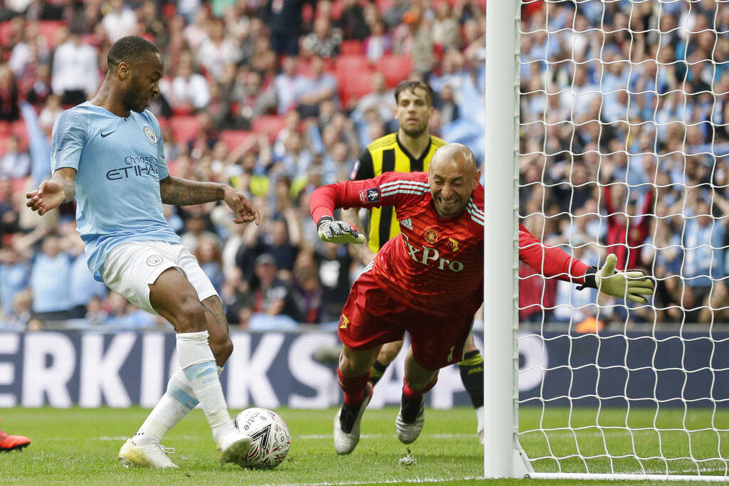 Manchester City's Raheem Sterling, left, scores his side's sixth goal past Watford's goalkeeper ...