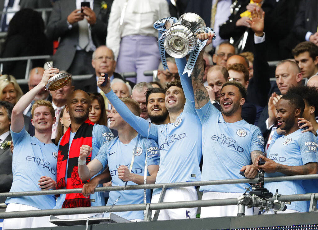 Manchester City players lift the trophy after the English FA Cup Final soccer match between Man ...