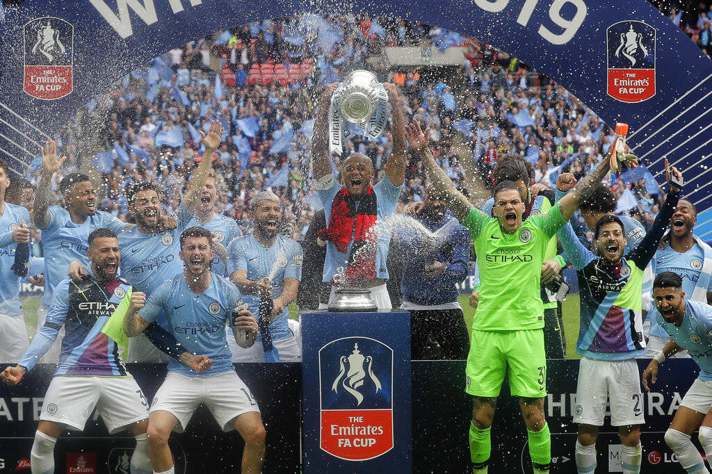 Manchester City players celebrate with the trophy after the English FA Cup Final soccer match b ...