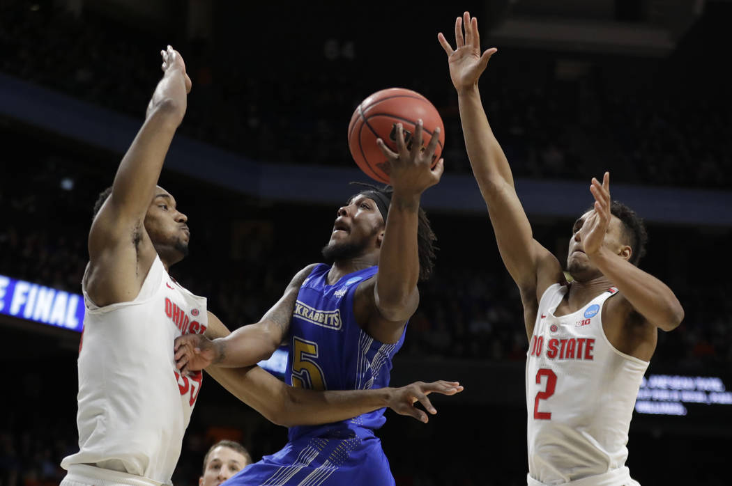 South Dakota State guard David Jenkins Jr. puts up a shot as Ohio State forward Keita Bates-Dio ...