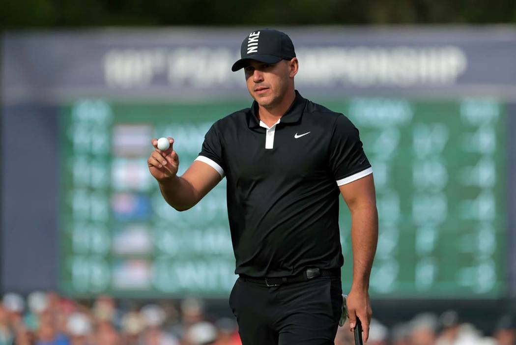 Brooks Koepka reacts after putting on the 13th green during the third round of the PGA Champion ...