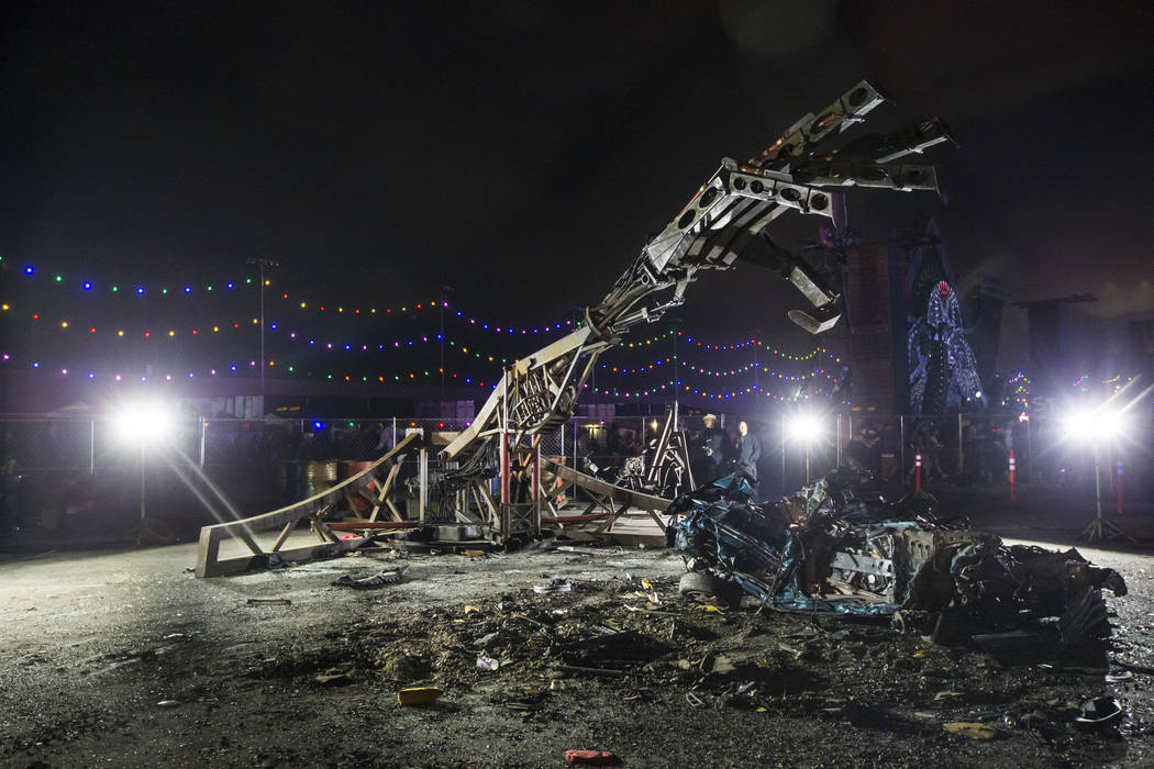 A smashed car is seen by The Hand of God during the second day of the Electric Daisy Carnival a ...