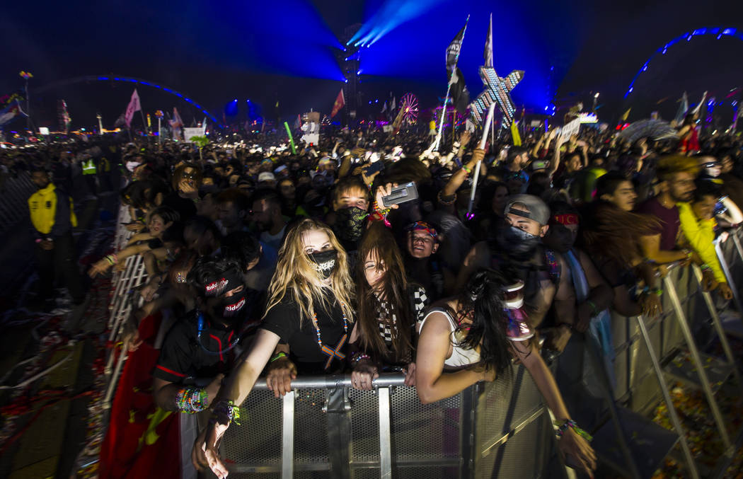 Attendees react as Excision performs at the Kinetic Field stage during the first day of the Ele ...